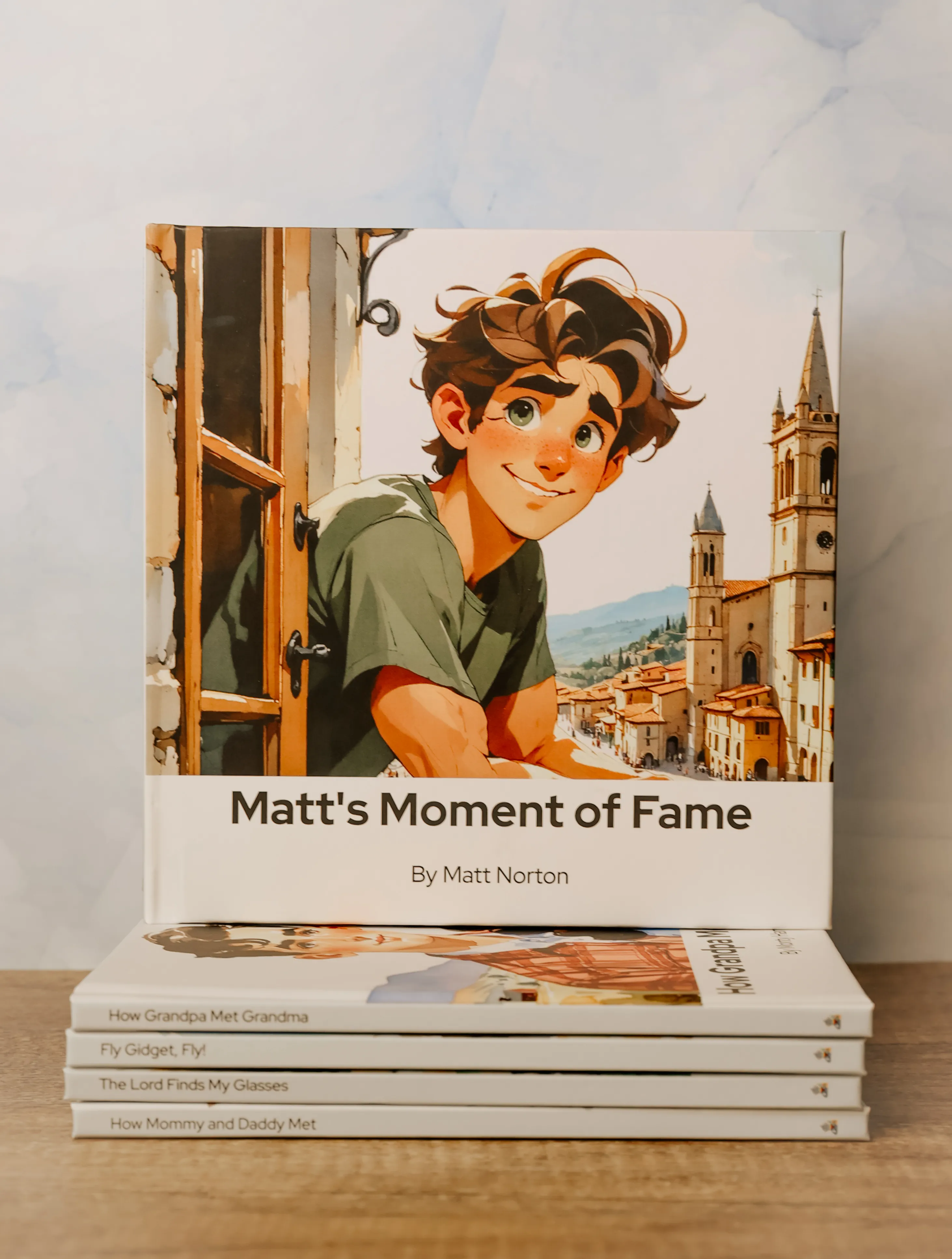 A finished Lore family storybook displayed on a stack of additional titles